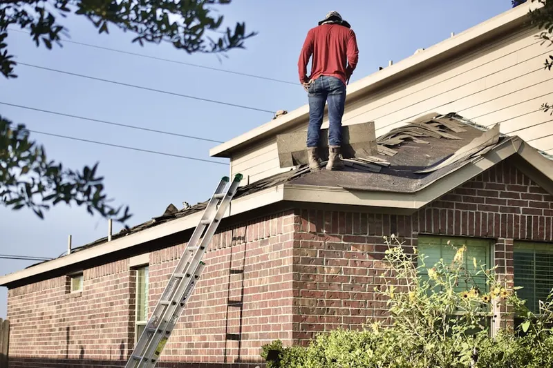 Professional roofer working on a residential roof in New Square